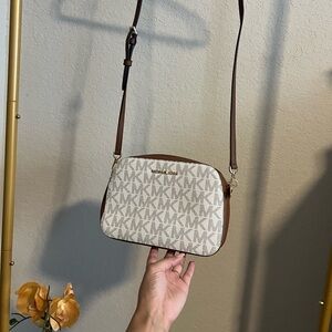 Michael Kors cross body bag. NWOT. Never Used. Off-white with MK logo.